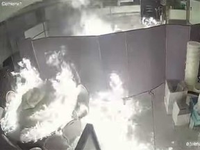 A restaurant is pictured being set on fire in this screengrab of surveillance video release by police in an investigation into an arson incident on Sept. 3, 2023