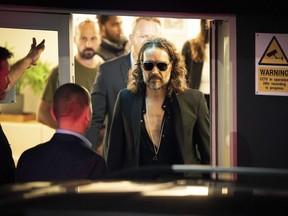 Russell Brand leaves the Troubabour Wembley Park theatre in northwest London after performing a comedy set on Saturday, Sept. 16, 2023.