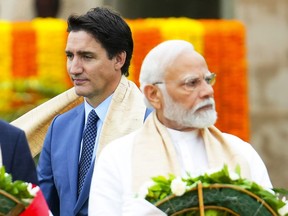 Canada's Prime Minister Justin Trudeau, left, walks past Indian Prime Minister Narendra Modi as they take part in a wreath-laying ceremony at Raj Ghat, Mahatma Gandhi's cremation site, during the G20 Summit in New Delhi, Sunday, Sept. 10, 2023.
