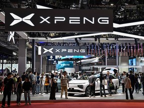 Visitors visit the Xpeng booth during the 20th Shanghai International Automobile Industry Exhibition on April 19, 2023 in Shanghai.