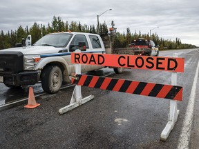 A road closed sign blocks the way to Yellowknife.