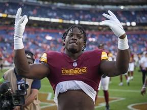 Washington Commanders running back Brian Robinson Jr. gestures to fans as he leaves the field after an NFL football game against the Denver Broncos, Sunday, Sept. 17, 2023, in Denver.