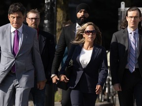 Lawyer Lawrence Greenspon (left) walks with Tamara Lich as they make their way to the courthouse on the first day of trial, in Ottawa, Tuesday, Sept. 5, 2023.