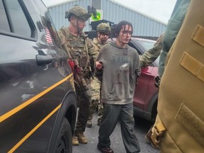 In this handout photo provided by the Pennsylvania State Police, fugitive Danelo Cavalcante is taken into custody on Sept. 13, 2023 by the Pennsylvania State Police in Pennsylvania.