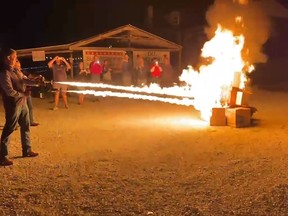 In this frame grab from video provided by Debbie McFarland, state Sen. Bill Eigel torches a pile of cardboard boxes at a "Freedom Fest" event in Defiance, Mo., Sept. 15, 2023.