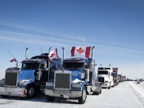 A truck convoy of anti-COVID-19 vaccine mandate demonstrators continue to block the highway at the busy U.S. border crossing in Coutts, Alta., Wednesday, Feb. 2, 2022.THE CANADIAN PRESS/Jeff McIntosh
