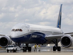 Boeing employees walk the new Boeing 787-10 Dreamliner down towards the delivery ramp area