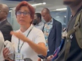 Portugal airport employee attending to passengers diverted from Ghana to NYC.