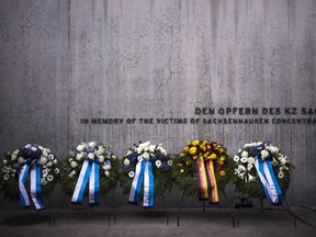 FILE - Wreaths at the memorial wall of the Nazi concentration camp Sachsenhausen after a ceremony marking the Holocaust Martyrs' and Heroes' Remembrance Day in Oranienburg, Germany, Tuesday, April 18, 2023. German prosecutors say a 98-year-old man has been charged with being an accessory to murder as a guard at the Nazis' Sachsenhausen concentration camp between 1943 and 1945. Nazis' Sachsenhausen concentration camp between 1943 and 1945.