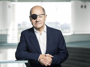 German Chancellor Olaf Scholz with a black eye-patch