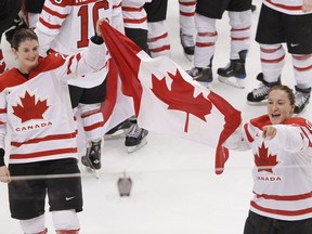 Gina Kingsbury is the general manager of the Professional Women's Hockey League's team in Toronto. Kingsbury, left, and Colleen Sostorics celebrate with the flag after winning the gold medal ice hockey game against the United States at the 2010 Olympics in Vancouver, B.C., Thursday, Feb. 25, 2010.