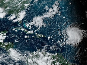 This satellite image provided by the National Oceanographic and Atmospheric Administration shows Hurricane Lee, right, in the Atlantic Ocean on Friday, Sept. 8, 2023, at 4:50 p.m. EDT. Though the track of hurricane Lee remains unclear, anxiety created by powerful storms is a growing reality on the East Coast -- especially in communities that felt Fiona's wrath last year. THE CANADIAN PRESS/AP-NOAA via AP