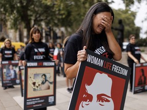 A woman reacts as she takes part in a protest ahead of the first anniversary of the death of Mahsa Amin, on Sept. 13, 2023 in London.