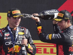 Second placed Red Bull driver Sergio Perez of Mexico, right, celebrates on the podium with winner Red Bull driver Max Verstappen of the Netherlands after the Formula One Italian Grand Prix auto race, at the Monza racetrack, in Monza, Italy, Sunday, Sept. 3, 2023.