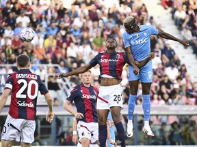 Napoli's Victor Osimhen, top right, heads the ball during the Serie A soccer match between Bologna and Napoli at the Renato Dall'Ara stadium in Bologna, Italy, Sunday, Sept. 24, 2023.