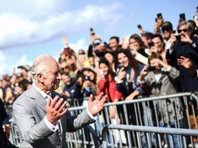 King Charles III gestures to the crowd at Place de la Bourse on the third day of his State Visit to France in Bordeaux, southwestern France, on Sept. 22, 2023.