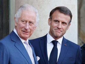 King Charles III, left, and French President Emmanuel Macron pose on the steps of the Elysee Presidential Palace in Paris