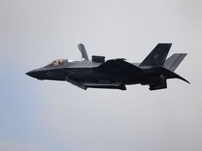 FILE - A United States Marine Corps F-35B Lightning II takes part in an aerial display during the Singapore Airshow 2022 at Changi Exhibition Centre in Singapore, Feb. 15, 2022. A Marine Corps pilot safely ejected from a fighter jet over South Carolina and the search for his missing aircraft was focused on two lakes near North Charleston. Military officials say the pilot parachuted safely into a North Charleston neighborhood Sunday Sept. 17, 2023. He was taken to a hospital and was in stable condition. The pilot's name has not been released. A search for the missing F-35 was focused on Lake Moultrie and Lake Marion, which are north of North Charleston.