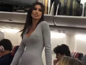 Woman in grey bodysuit leaving plane