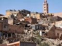 The minaret of a mosque stands behind damaged or destroyed houses following an earthquake in Moulay Brahim, Al-Haouz province, on Sept. 9, 2023. 