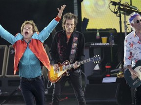 Mick Jagger, left, Ronnie Wood, centre, and Keith Richards, right, of The Rolling Stones, perform onstage during the last concert of their "Sixty" European tour in Berlin, Germany, Aug. 3, 2022.