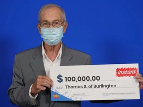 Thomas Scoccia poses with a cheque. (Supplied by OLG)