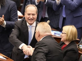 Finance Minister Peter Bethlenfalvy shakes hands with Premier Doug Ford March 23, 2023.