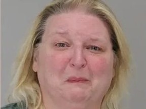 Mugshot of teary, crying blond woman.