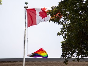 Canadian and Pride flags are pictured at Carlton Village Public School in the west end of Toronto on Tuesday, June 6, 2023.