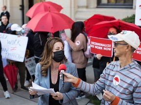Jenn Clamen, national coordinator for the Canadian Alliance for Sex Work Law Reform, speaks during a rally outside the Ontario Superior Court after the launch of their constitutional challenge to Canada's sex work laws, on Monday, October 3, 2022.