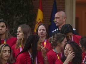 FILE - Then President of Spain's soccer federation, Luis Rubiales, top right, stands with Spain's Women's World Cup soccer team after their World Cup victory at La Moncloa Palace in Madrid, Spain, on Aug. 22, 2023. One day before Spain's new women's coach announces her first squad, the players who won the Women's World Cup have yet to say if they are ready to come back to the team after rebelling against their disgraced former federation president. Spain's women have had little chance to celebrate their greatest soccer achievement because Luis Rubiales caused an uproar when he kissed a player on the lips without her consent at the awards ceremony last month in Sydney.