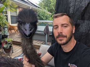 Nicholas Olenik with Nimbus, his emotional support emu.