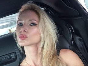 Selfie of attractive blonde woman making kissy face