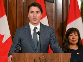 Prime Minister Justin Trudeau speaks next to his International Trade Minister Mary Ng at a press conference during a stopover visit to Singapore on Sept. 8, 2023.