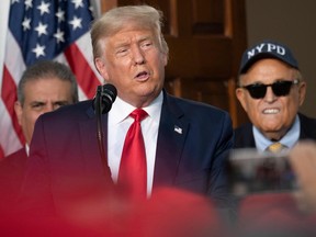Rudy Giuliani listens as President Donald Trump delivers remarks