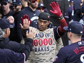 Minnesota Twins' Jorge Polanco celebrates with teammates after hitting a solo home run during the eighth inning of a baseball game against the Chicago White Sox in Chicago, Sunday, Sept. 17, 2023.