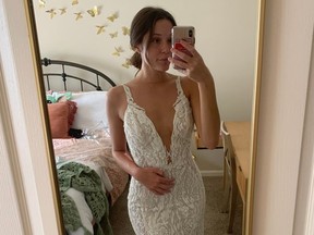 Emmali Osterhoudt wears a Galia Lahav wedding dress she bought for $24.99 at a Goodwill store in Birmingham, Ala. Similar dresses by the designer typically sell for $6,200.