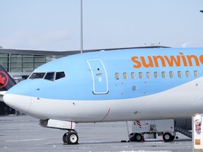 A Sunwing aircraft is parked at Montreal Trudeau airport in Montreal on Wednesday, March 2, 2022.