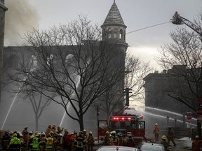 Firefighters at the scene of fire on Du Port street in Old Montreal on March 16, 2023.