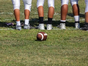 High school football players prepare for a play.
