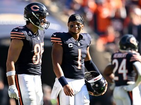 Justin Fields of the Chicago Bears walks with Cole Kmet after throwing an interception against the Denver Broncos.