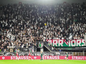 Legia Warsaw fans cheer during the UEFA Conference League 1st round Group E football match between AZ Alkmaar and Legia Warsaw.