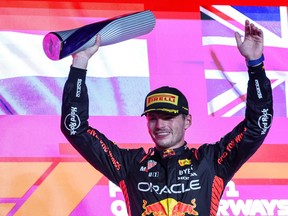 Red Bull Racing driver Max Verstappen celebrates on the podium following the Qatari Formula One Grand Prix at Lusail International Circuit.