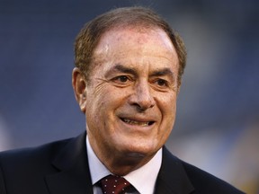 TV personality Al Michaels stands on the field before a game between the New England Patriots and the San Diego Chargers.