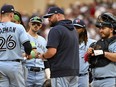 John Schneider of the Toronto Blue Jays talks with the team against the Minnesota Twins.