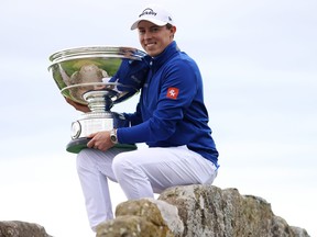 Matt Fitzpatrick poses with the trophy on the Swilcan Bridge following victory on Day Five of the Alfred Dunhill Links Championship.