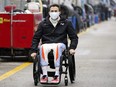 Robert Wickens makes his way to his pit stall during practice for the Rolex 24 hour auto race at Daytona International Speedway in 2022