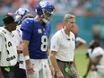 New York Giants quarterback Daniel Jones is escorted off the field during the second half of an NFL football game against the Miami Dolphins.