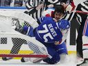 Montreal Canadiens' Arber Xhekaj (72) and Toronto Maple Leafs' Ryan Reaves (75) knock over the net as they fight.
