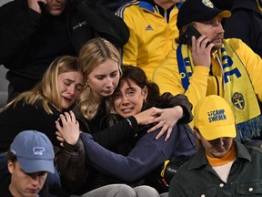 Swedish supporters react as they wait in the stand during the Euro 2024 qualifying football match.